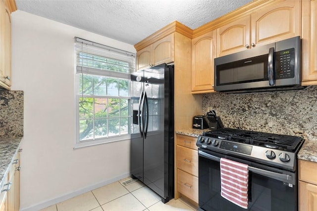 3269 Dawson St, Oakland, PA 15213 - kitchen with stainless steel appliances, light brown cabinetry, tasteful backsplash, light tile patterned floors, and a textured ceiling