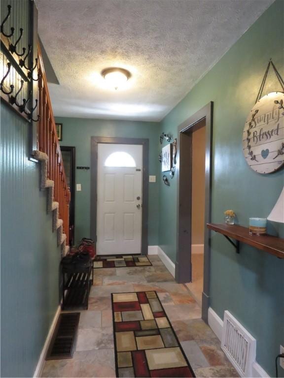 103 Cedar St, Masontown, PA 15461 - foyer with a textured ceiling, stairs, and light stone finish floors