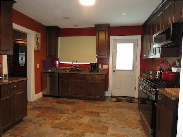 103 Cedar St, Masontown, PA 15461 - kitchen featuring appliances with stainless steel finishes, dark brown cabinetry, and light stone finish floors