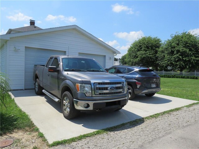 103 Cedar St, Masontown, PA 15461 - view of home's exterior with a detached garage, a yard, and a chimney