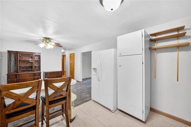215 Diane Dr, Carroll Twp, PA 15063 - kitchen with white fridge with ice dispenser, light wood finished floors, and a ceiling fan