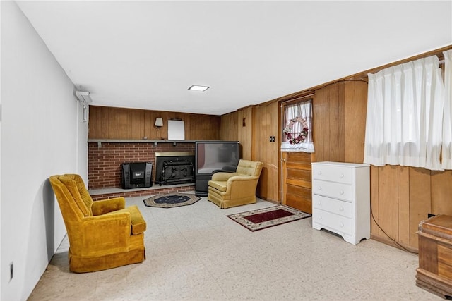 215 Diane Dr, Carroll Twp, PA 15063 - sitting room featuring wooden walls and a wood stove
