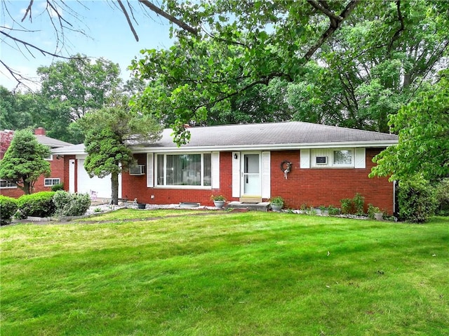 215 Diane Dr, Carroll Twp, PA 15063 - ranch-style home with brick siding, a front yard, and an attached garage