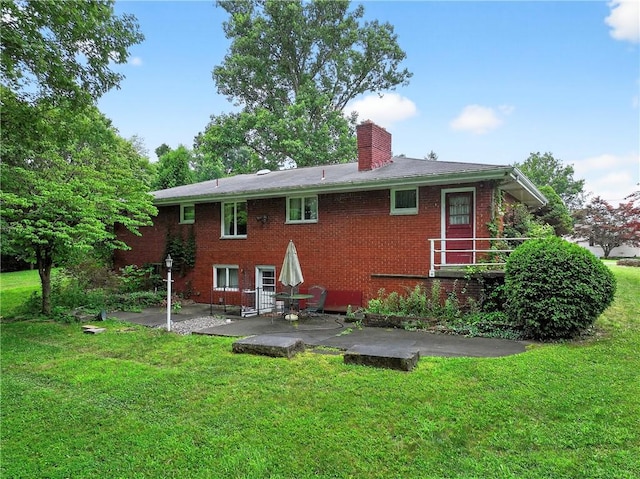 215 Diane Dr, Carroll Twp, PA 15063 - rear view of house with a patio, a chimney, brick siding, and a yard