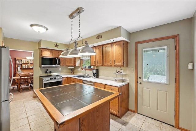 103 Sanger Rd, North Sewickley Twp, PA 15010 - kitchen with appliances with stainless steel finishes, light tile patterned flooring, brown cabinets, and tasteful backsplash