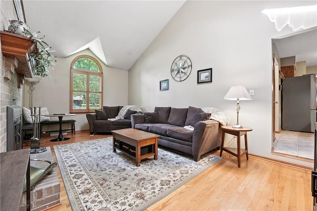 103 Sanger Rd, North Sewickley Twp, PA 15010 - living room with light wood-style floors, vaulted ceiling, and a brick fireplace