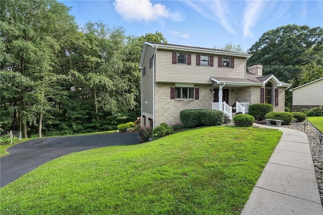 103 Sanger Rd, North Sewickley Twp, PA 15010 - view of front of home with a front lawn, asphalt driveway, brick siding, and a chimney