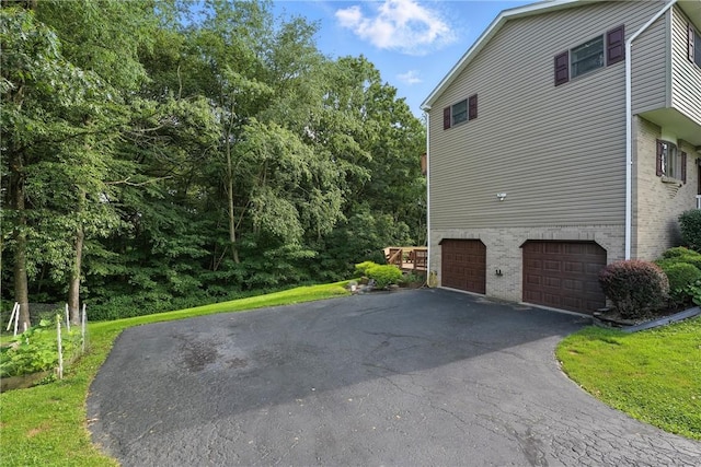 103 Sanger Rd, North Sewickley Twp, PA 15010 - view of side of property featuring an attached garage, driveway, and brick siding