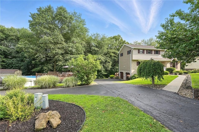 103 Sanger Rd, North Sewickley Twp, PA 15010 - view of grassy yard featuring driveway, an outdoor pool, a deck, and an attached garage