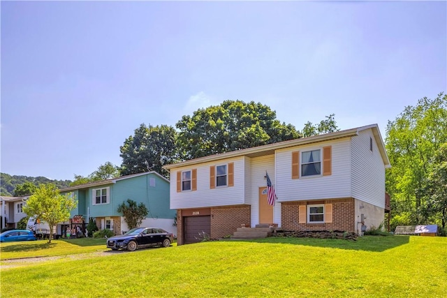 2128 Stoops Ct, Apollo Boro, PA 15673 - split foyer home featuring an attached garage, brick siding, driveway, and a front yard