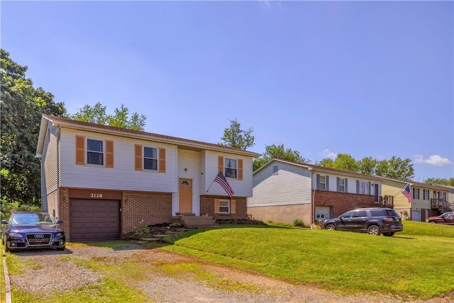 2128 Stoops Ct, Apollo Boro, PA 15673 - bi-level home with brick siding, an attached garage, driveway, and a front lawn