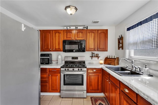 2128 Stoops Ct, Apollo Boro, PA 15673 - kitchen featuring black microwave, gas range, and brown cabinetry