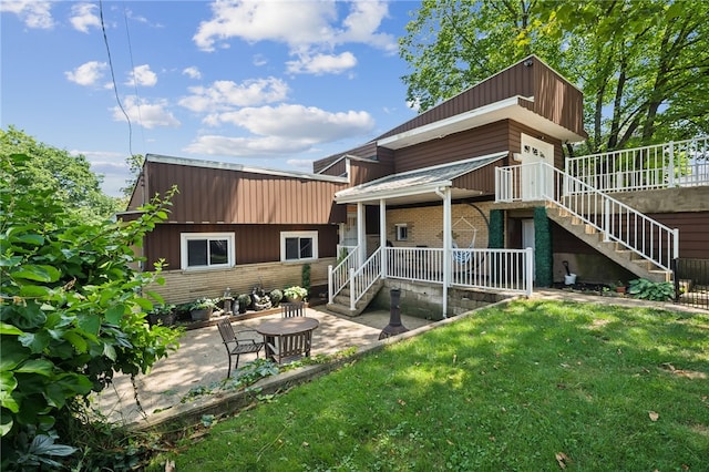 4075 Greensburg Pike, Wilkins Twp, PA 15221 - back of house with stairway, a lawn, and brick siding
