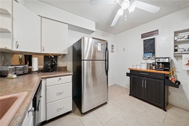 4075 Greensburg Pike, Wilkins Twp, PA 15221 - kitchen featuring freestanding refrigerator, white cabinets, light tile patterned floors, a ceiling fan, and dark cabinets