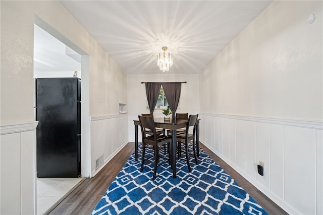 4075 Greensburg Pike, Wilkins Twp, PA 15221 - dining room with a chandelier, wood finished floors, wainscoting, and a decorative wall