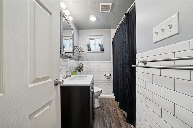 4075 Greensburg Pike, Wilkins Twp, PA 15221 - full bathroom featuring tile walls, vanity, a wainscoted wall, wood finished floors, and curtained shower