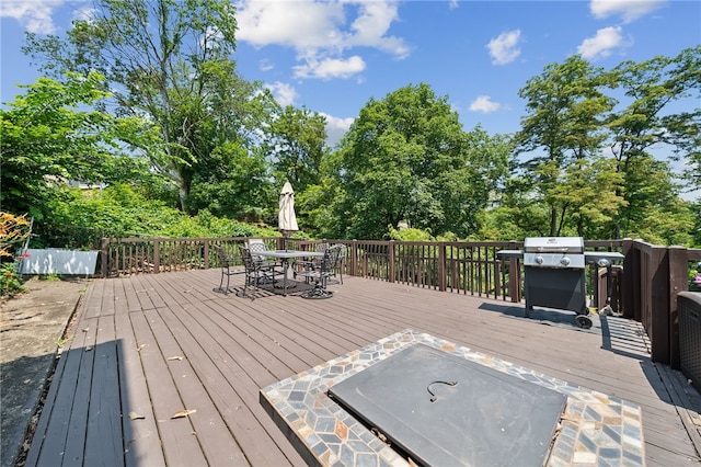 4075 Greensburg Pike, Wilkins Twp, PA 15221 - wooden deck with outdoor dining area, view of scattered trees, and grilling area