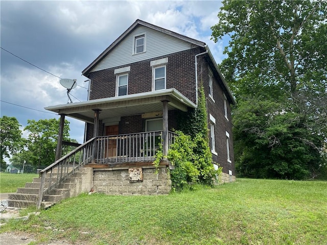807 Lee Ave, Farrell, PA 16121 - american foursquare style home with brick siding, covered porch, a front yard, and stairway