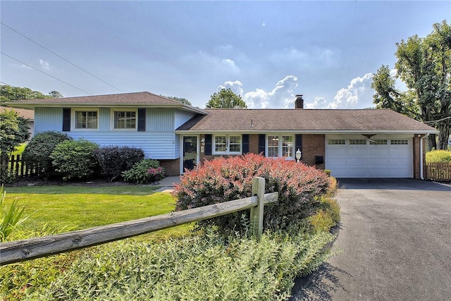 2 Redgrave Dr, Hempfield Twp, PA 15601 - view of front facade with asphalt driveway, an attached garage, a chimney, and brick siding