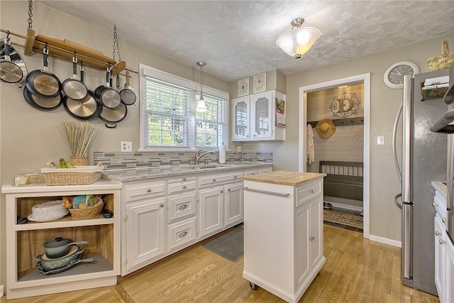 2 Redgrave Dr, Hempfield Twp, PA 15601 - kitchen with freestanding refrigerator, white cabinetry, light wood-type flooring, and butcher block counters
