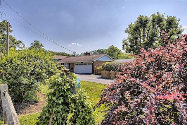 2 Redgrave Dr, Hempfield Twp, PA 15601 - view of front of home with an attached garage, asphalt driveway, brick siding, and a chimney