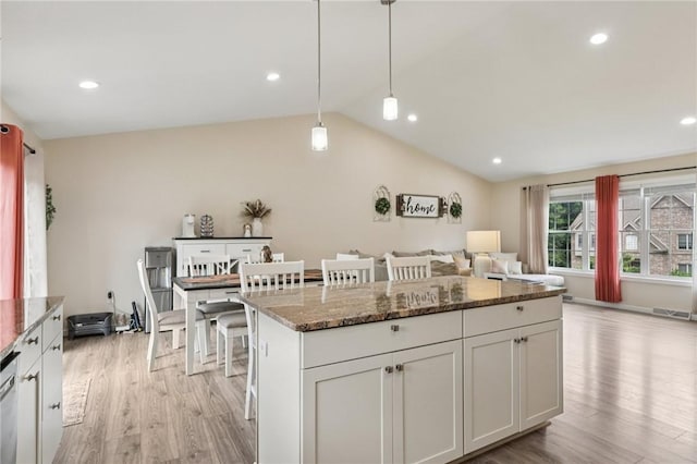 196 Weathervane Dr, Slippery Rock Twp, PA 16057 - kitchen with light wood-type flooring, dark stone countertops, open floor plan, lofted ceiling, and a kitchen island
