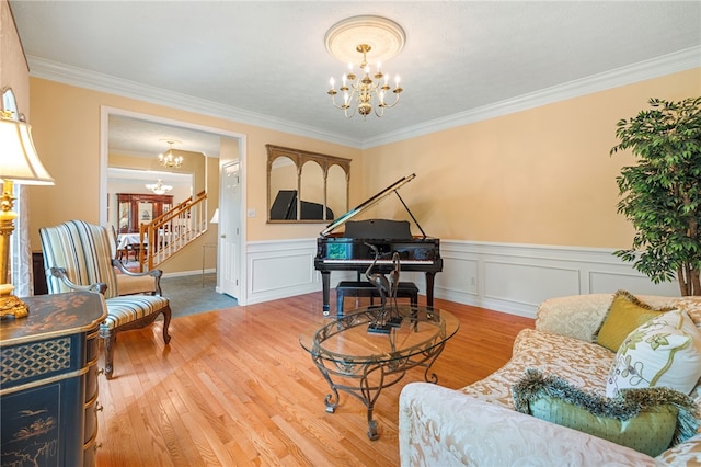 113 Great Rock Dr, Bethel Park, PA 15102 - living area featuring a chandelier, wood finished floors, crown molding, wainscoting, and stairway