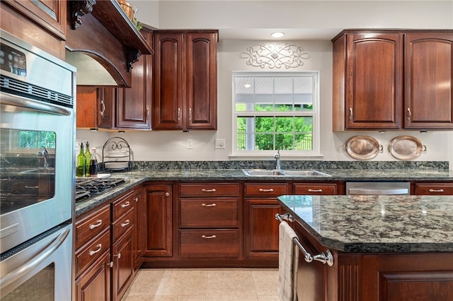113 Great Rock Dr, Bethel Park, PA 15102 - kitchen with dark stone counters, custom exhaust hood, appliances with stainless steel finishes, light tile patterned floors, and recessed lighting