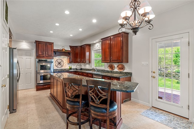 113 Great Rock Dr, Bethel Park, PA 15102 - kitchen with stainless steel appliances, a center island, a chandelier, recessed lighting, and dark stone countertops