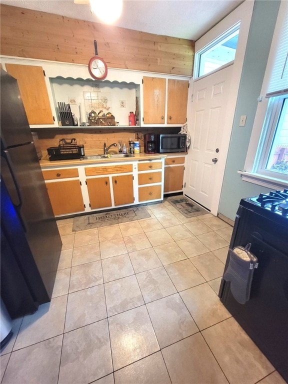 413 River Ave, Aliquippa, PA 15001 - kitchen featuring light tile patterned flooring, light countertops, and wood walls