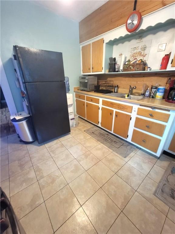 413 River Ave, Aliquippa, PA 15001 - kitchen with freestanding refrigerator, light tile patterned floors, and light countertops