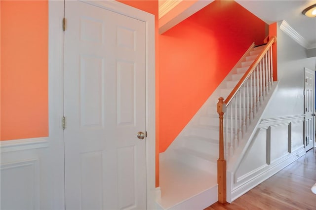 184 Wynne St, Shaler, PA 15209 - staircase featuring crown molding, wainscoting, a decorative wall, and wood finished floors