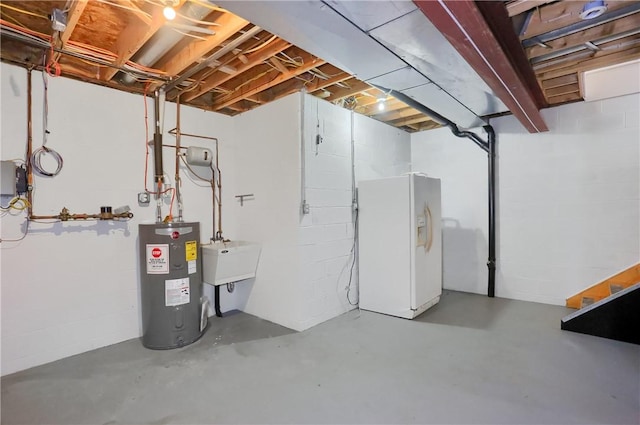 184 Wynne St, Shaler, PA 15209 - unfinished below grade area featuring white refrigerator with ice dispenser, electric water heater, and concrete block wall