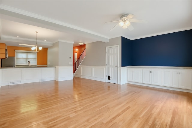 184 Wynne St, Shaler, PA 15209 - unfurnished living room with light wood-type flooring, a ceiling fan, a wainscoted wall, stairway, and ornamental molding