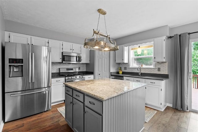 53 Peters Rd, Hempfield Twp, PA 15601 - kitchen with stainless steel appliances, hardwood / wood-style flooring, tasteful backsplash, and white cabinets