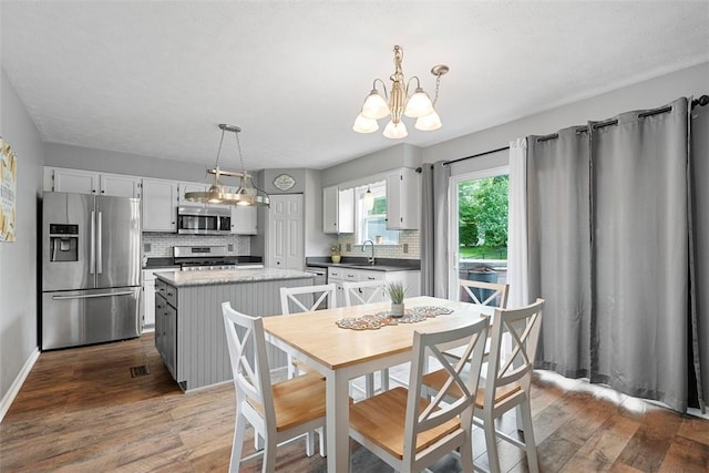 53 Peters Rd, Hempfield Twp, PA 15601 - dining area with a chandelier and dark wood-type flooring
