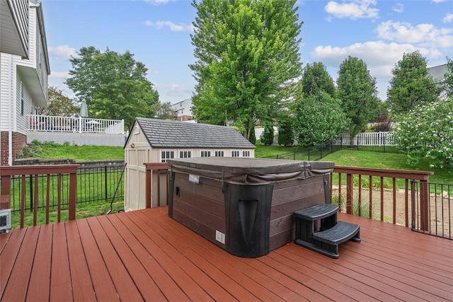 53 Peters Rd, Hempfield Twp, PA 15601 - wooden deck featuring a hot tub, a fenced backyard, and a storage shed
