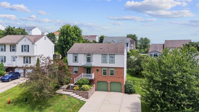 53 Peters Rd, Hempfield Twp, PA 15601 - view of front of house featuring driveway, a garage, a residential view, brick siding, and a balcony