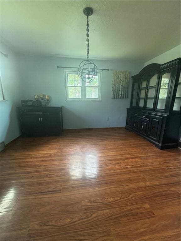 13 Kepple St, Penn Twp, PA 15644 - unfurnished dining area with a chandelier and dark wood-style flooring