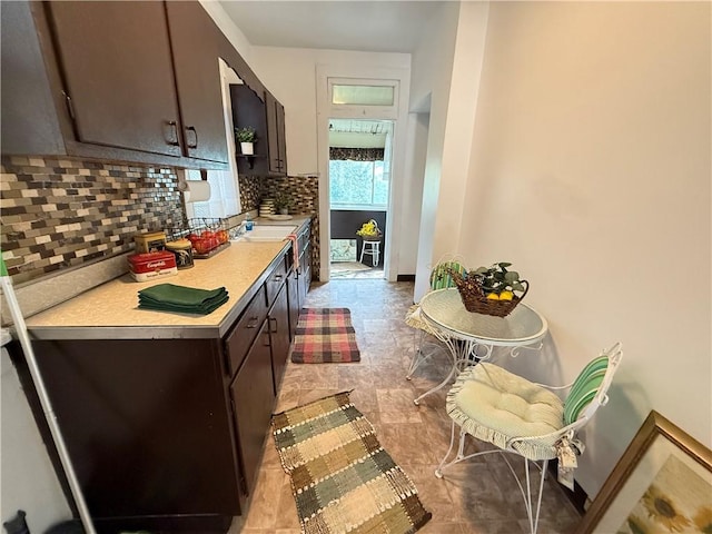 149 N 3rd St, Duquesne, PA 15110 - kitchen with backsplash, light countertops, and dark brown cabinets
