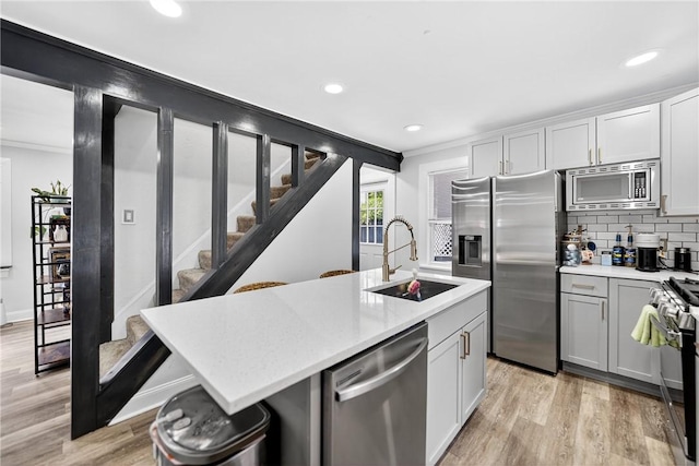 411 Center Ave, West View, PA 15229 - kitchen featuring stainless steel appliances, light countertops, light wood-type flooring, tasteful backsplash, and recessed lighting