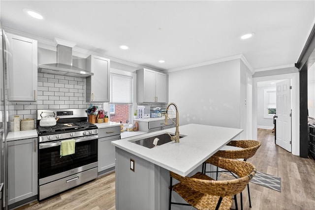 411 Center Ave, West View, PA 15229 - kitchen featuring stainless steel range with gas stovetop, wall chimney exhaust hood, gray cabinets, ornamental molding, and light countertops