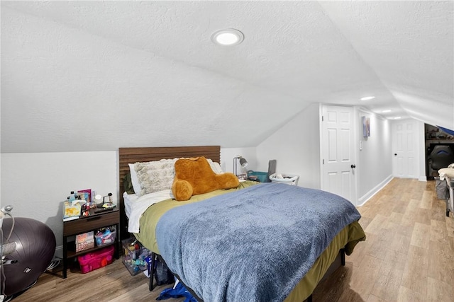 411 Center Ave, West View, PA 15229 - bedroom featuring a textured ceiling, light wood finished floors, and vaulted ceiling