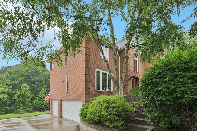 308 Heather Hill Dr, Pine Twp, PA 15044 - view of side of home featuring concrete driveway, brick siding, and an attached garage