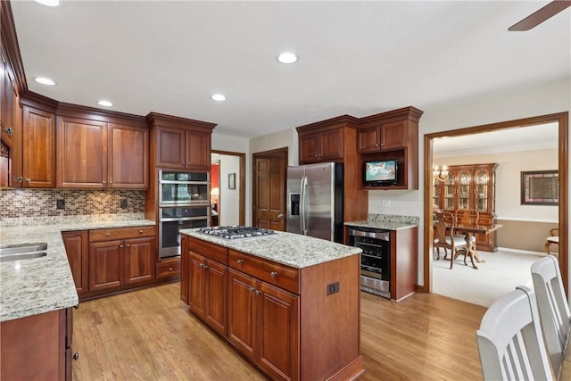 308 Heather Hill Dr, Pine Twp, PA 15044 - kitchen featuring appliances with stainless steel finishes, wine cooler, light wood finished floors, a center island, and recessed lighting