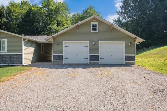 113 Betty Ln, Butler, PA 16002 - view of front of home featuring gravel driveway, a garage, and stone siding