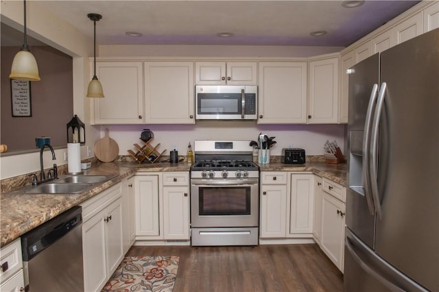 113 Betty Ln, Butler, PA 16002 - kitchen featuring appliances with stainless steel finishes, dark wood-type flooring, pendant lighting, and white cabinetry