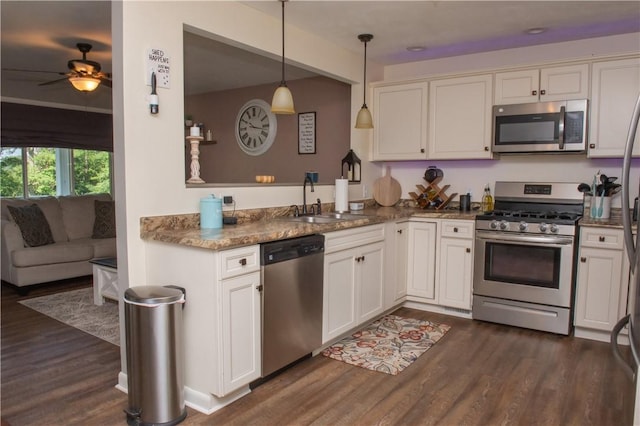 113 Betty Ln, Butler, PA 16002 - kitchen featuring stainless steel appliances, dark wood-style floors, ceiling fan, hanging light fixtures, and white cabinetry