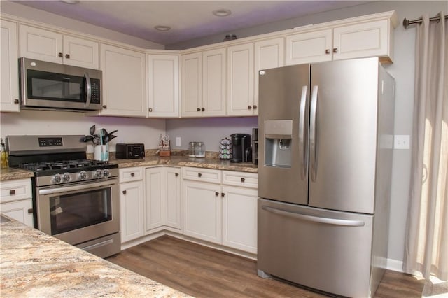 113 Betty Ln, Butler, PA 16002 - kitchen with appliances with stainless steel finishes, dark wood finished floors, recessed lighting, light stone counters, and white cabinets