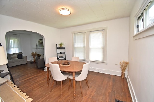 1804 Ridge Ave, Coraopolis, PA 15108 - dining area featuring arched walkways, plenty of natural light, and dark wood-style flooring